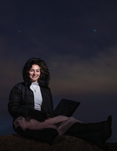 woman sitting outside at night
