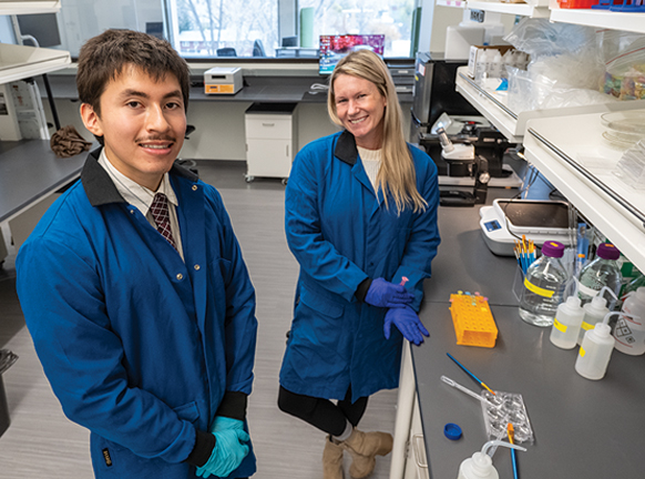 man and woman in lab coats working in a lab