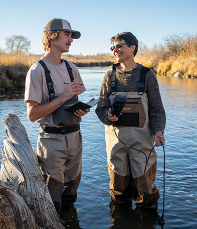 man and woman standing in the Laramie River