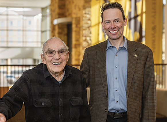 man poses with older man