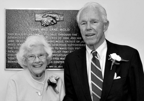 archive image older man and woman in front of a plaque