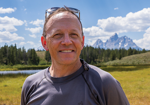 man posing outside in the mountains