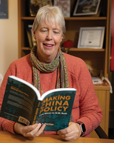 Woman sitting in an office reading a book