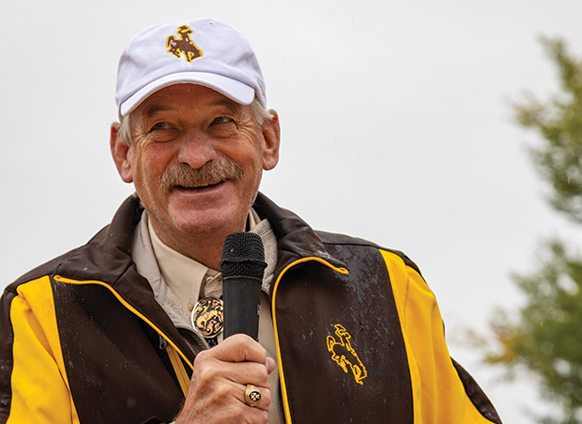 older man speaking into a microphone