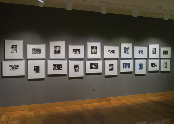 Wall of framed art in the Art Museum