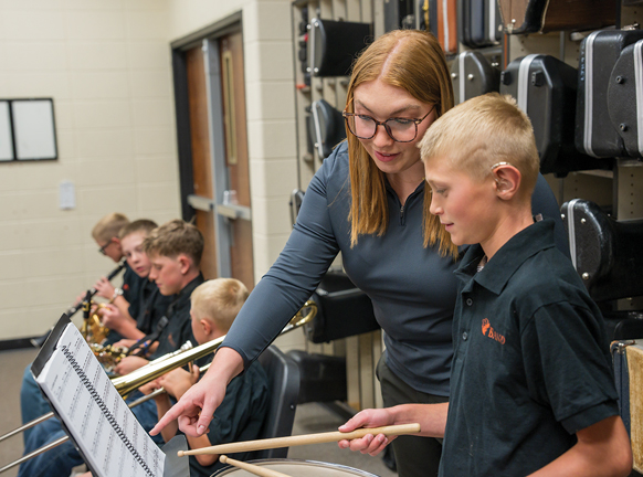 music teacher and student practice drums