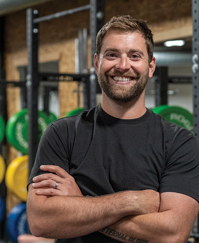 Man with crossed arms in a gym