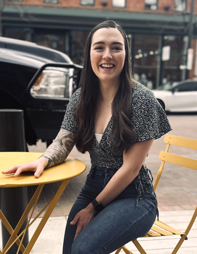 Person sits outside at a table in downtown Laramie