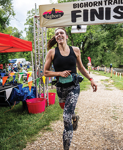 Female runner crosses the finish line at a race
