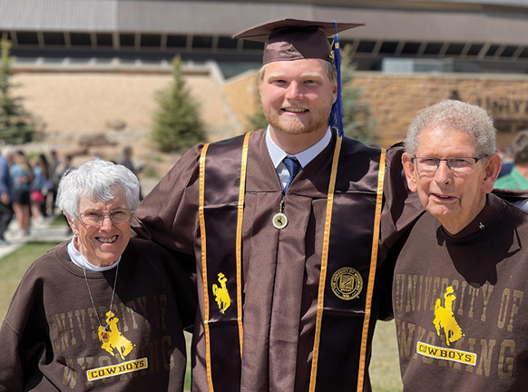 UW graduate with his grandparents at commencement
