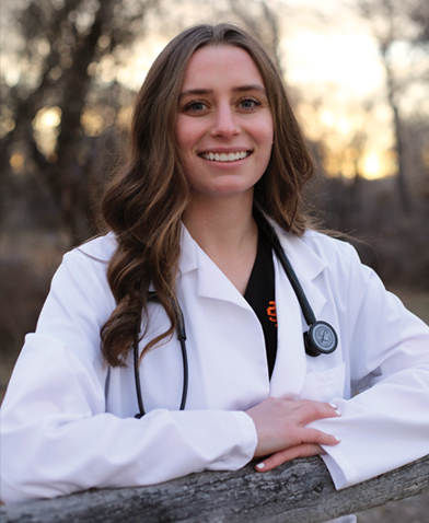 person posing outside in a medical coat and stethosope