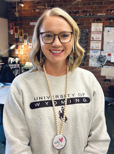 Teacher with a UW sweatshirt in a classroom