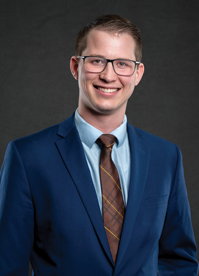 Person in a blue suit and brown tie