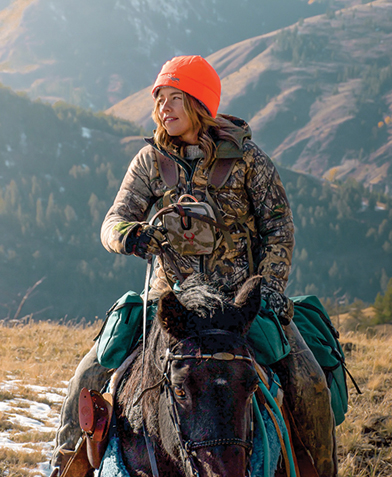 Person riding on a horse in the mountains