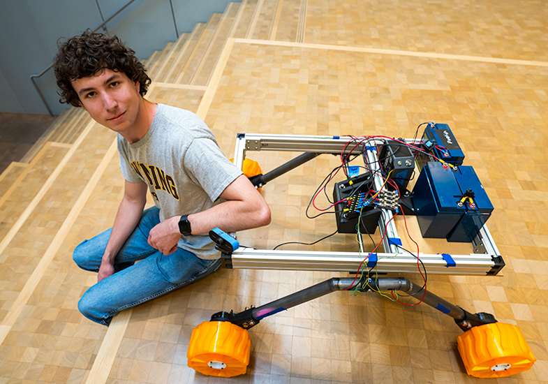 person sitting on stairs next to a robot
