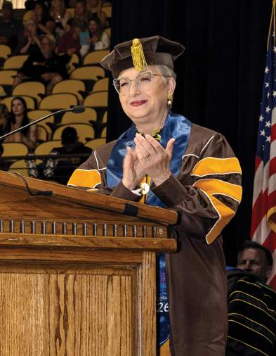 Person speaking at a podium at commencement