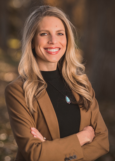 Woman in brown jacket and black shirt