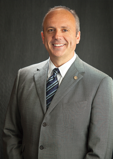 man in gray suit with a blue striped tie