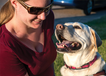 woman with yellow Labrador retriever