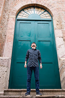 person standing in front of a teal door