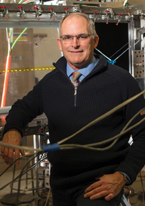 man posing behind cables in a lab