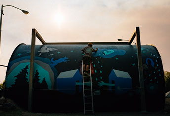 person painting a mural