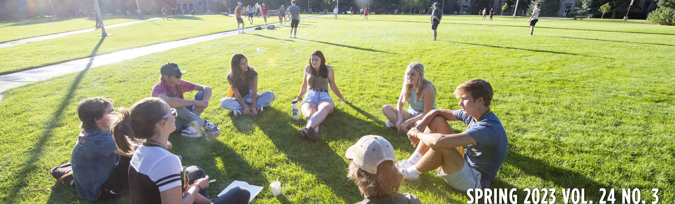people sitting in a circle in the grass