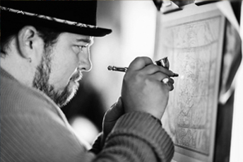 black and white photo of a man drawing