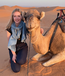 woman posing with a camel