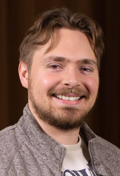 man with brown hair and a beard