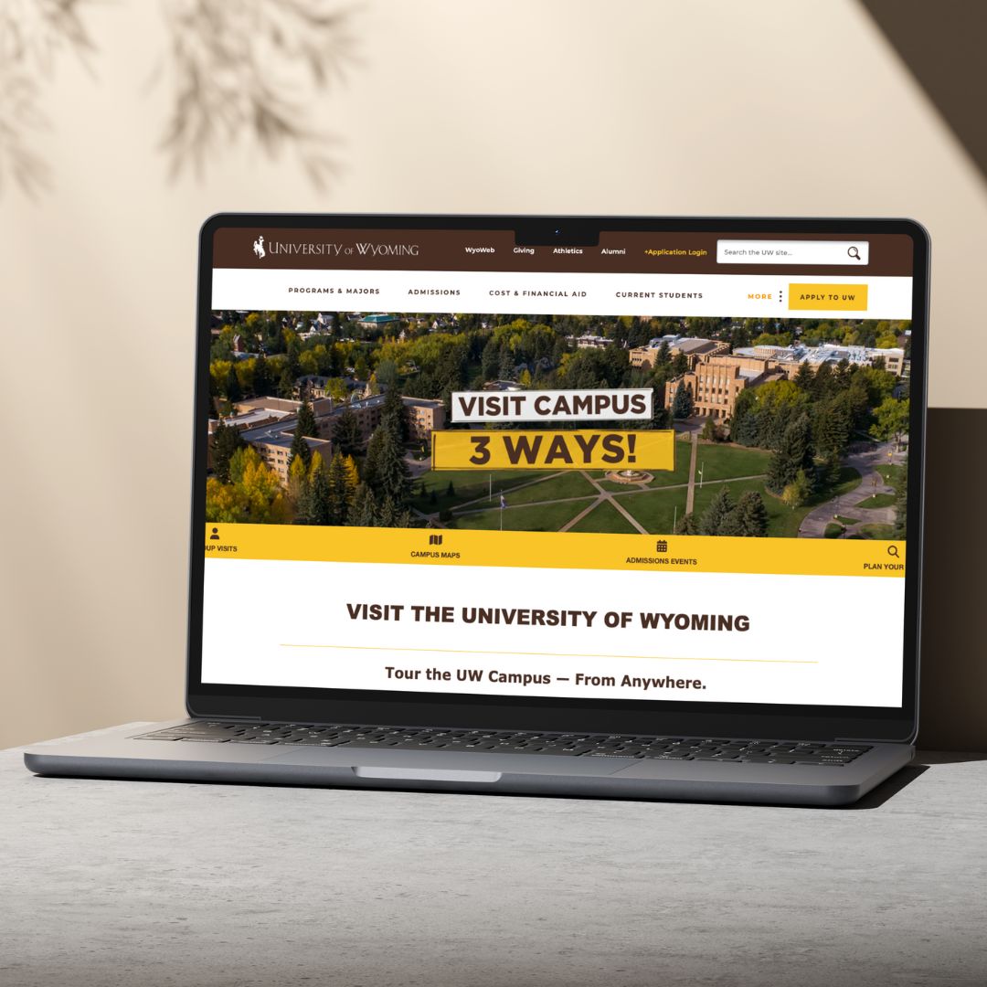 A laptop computer with the UW admissions visit page displayed on the screen.