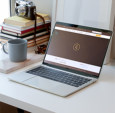 a laptop computer is open on a desk next to a mug and the screen is opened to a UW webpage