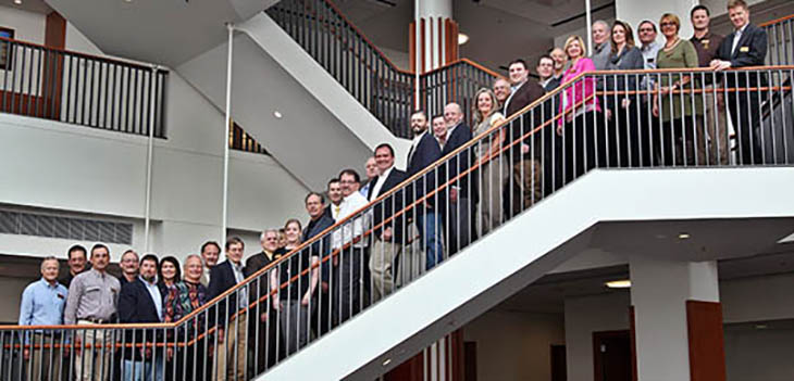 Students and staff pose for a photo in the UW College of Business. 