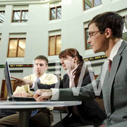 Students studying in the College of Business Atrium