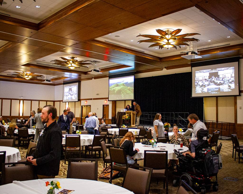 Gala attendees gather in the presentation room for Jim Warne's presentation.