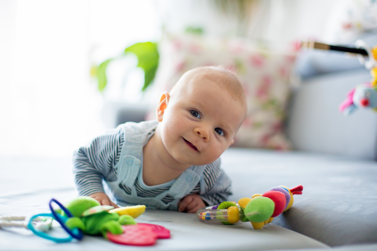 baby doing tummy time on a play mat