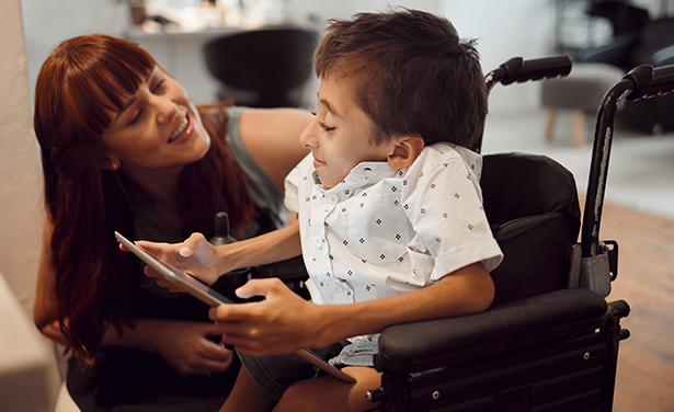 woman talking to young person in wheelchair