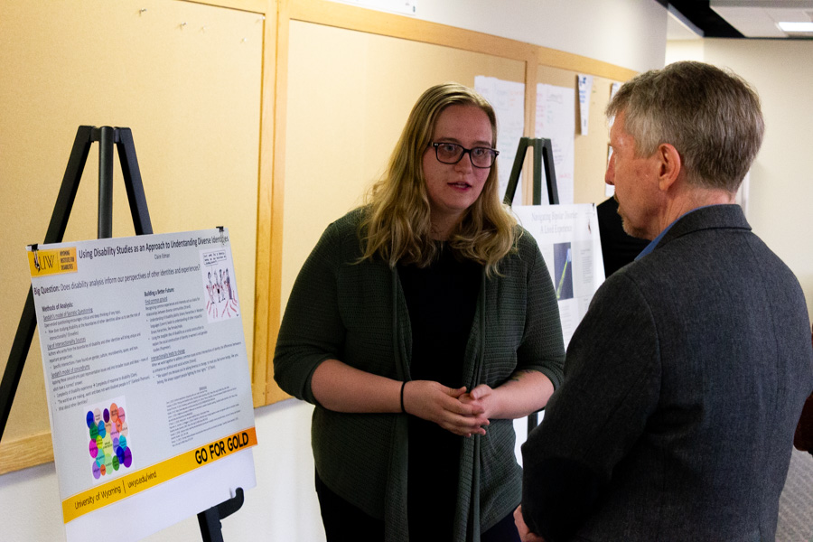 A disability studies minor student presents poster to Health Sciences Dean