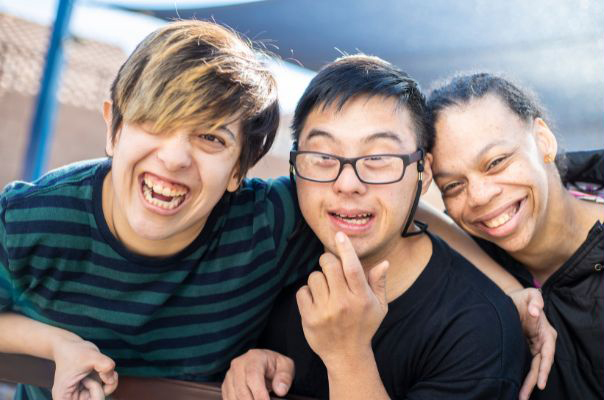 Three people smiling at the camera