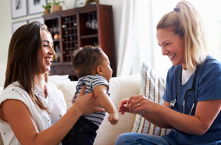 Mom and baby interact with nurse