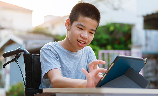 Boy in Wheelchair uses an IPad as Assistive Technology