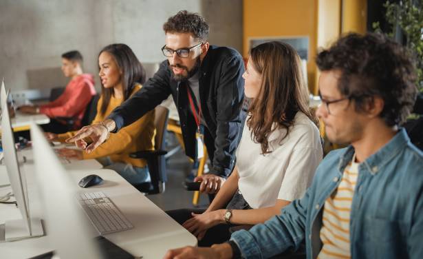 faculty member shows group things on the computer