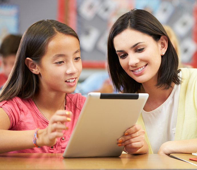 girl and teacher using an ipad