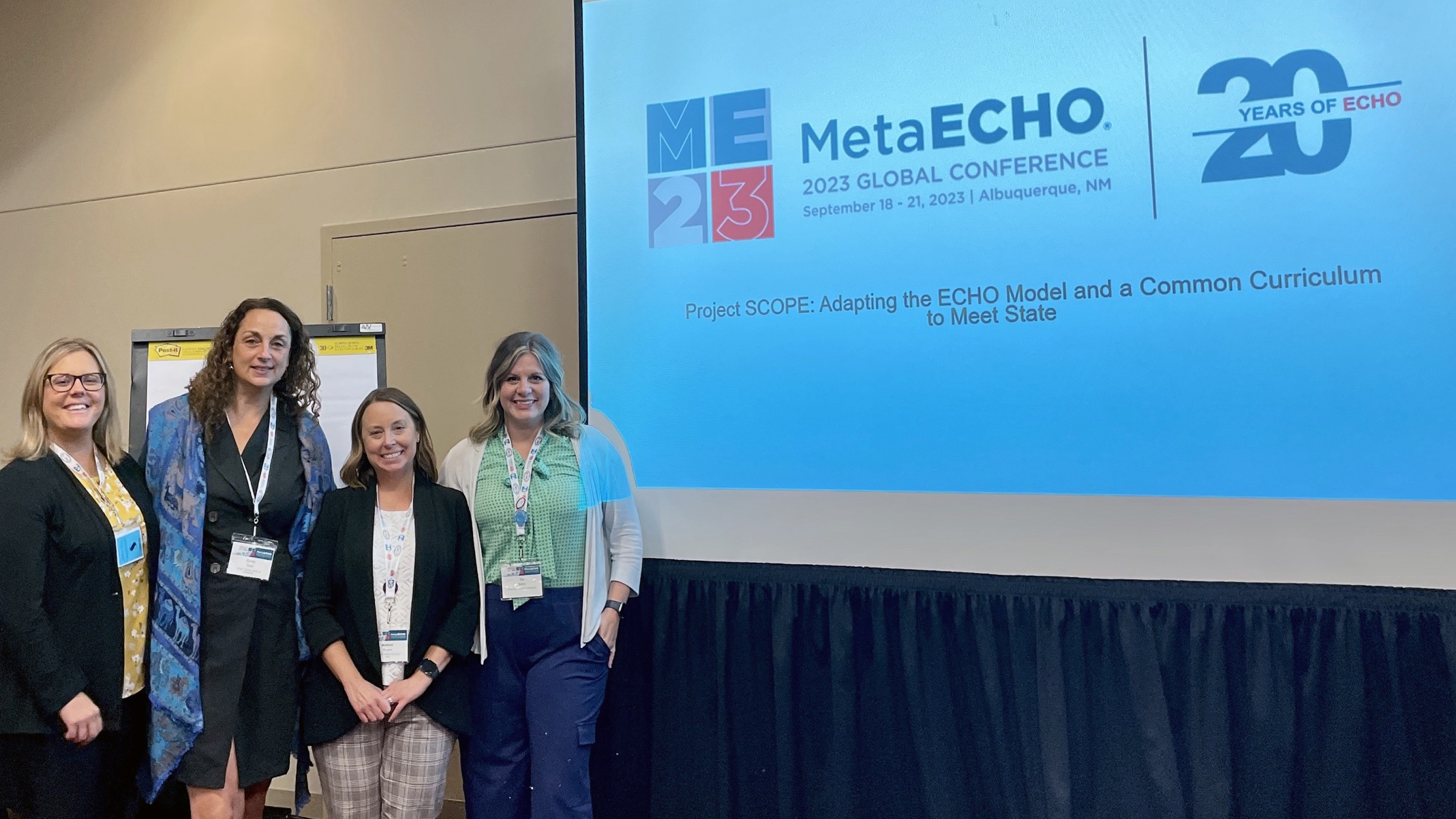 Two members of the WIND ECHO Team standing in front of a presentation for Project SCOPE