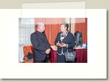 priest and woman talking at reception