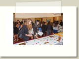 two participants exmaining materials on registration table