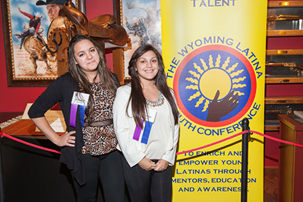 two standing next to banner