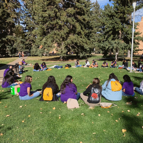 Youth Participants sitting in a circle on campus