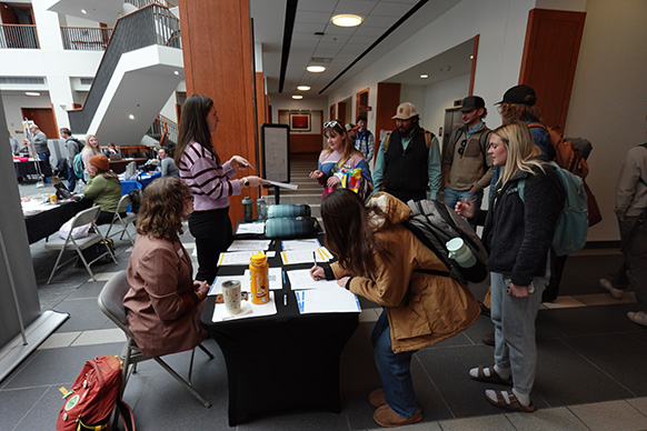 Jordan Kobliska, the Jay Kemmerer WORTH Insititute's internship and employment coordinator, directing University of Wyoming students at the 2026 Hospitality and Tourism fair.