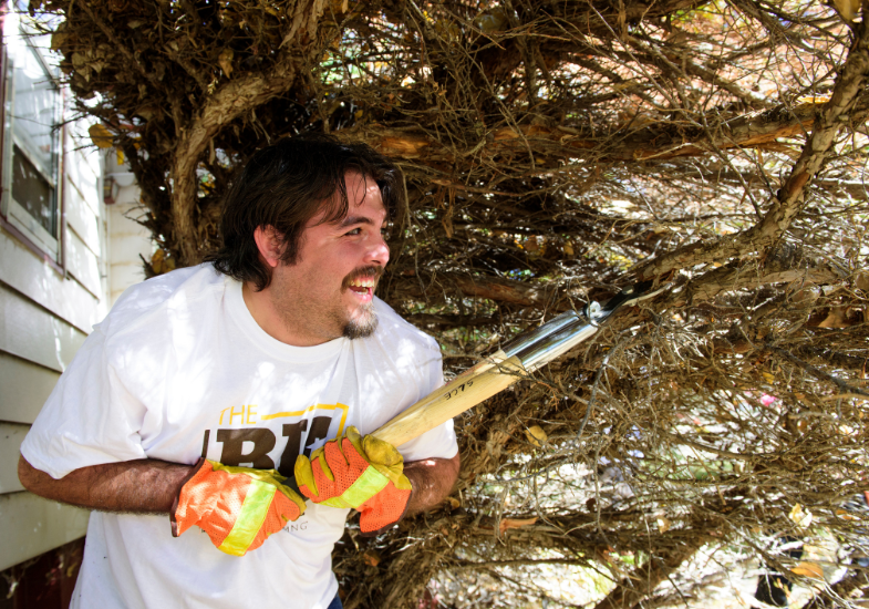 Smiling man uses shears